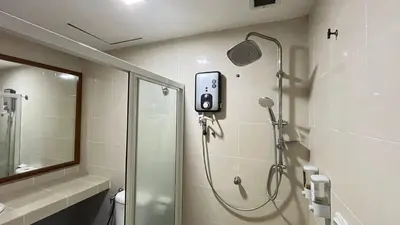 a bathroom with a shower and a glass showeroser at Cempaka Apartment by Easy Nap in Kuala Lumpur