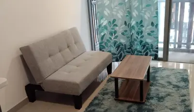 a living room with a chair and a coffee table at KL Comfy Masterbedroom wt bathroom in Kuala Lumpur