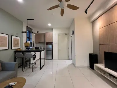 a living room with a couch and a ceiling fan at Regalia Residences and suits By Comfortcorner in Kuala Lumpur