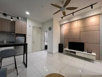 a living room with a television and a ceiling fan at Regalia Residences and suits By Comfortcorner in Kuala Lumpur