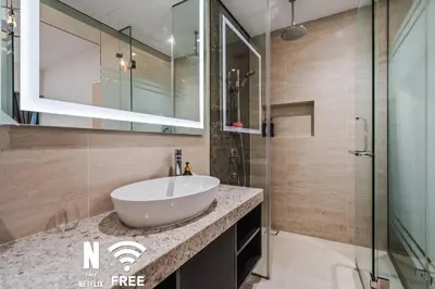 a bathroom with a sink and a glass shower at Comfy 1 BR unit 2 mins from KLCC in Kuala Lumpur