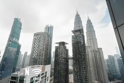 a view of a city skyline with tall buildings at 1BR| Rooftop Twin Towers View l Near LRT in Kuala Lumpur