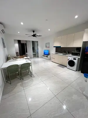 a kitchen with a table and a dining room at Comfort Cove in Kuala Lumpur