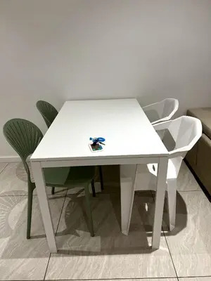 a white table and chairs in a room at Comfort Cove in Kuala Lumpur