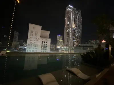a city skyline at night with a swimming pool at Comfort Cove in Kuala Lumpur