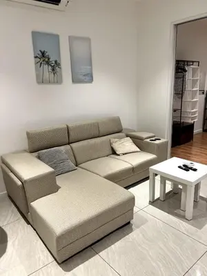 a living room with a couch and a table at Comfort Cove in Kuala Lumpur