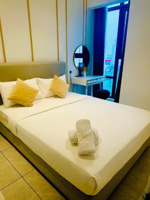 a large bed with two towels on top of it at AXON RESiDENCE AT SERViCE APARTMENT in Kuala Lumpur
