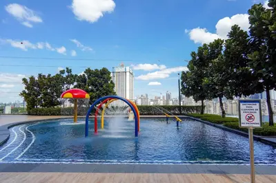 a pool with a water slide in a city at Kuala Lumpur M Vertica Residence I Big Family Homestay \u5927\u5bb6\u5ead\u9002\u4f4f I Walking distance to MRT I \u9a6c\u4e2d\u82f1\u6587\u670d\u52a1 I Malay English Chinese in Kuala Lumpur