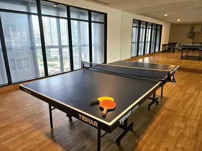 a ping pong table with a paddle on top of it at The Establishment - Menara Teguh Bangsar in Kuala Lumpur