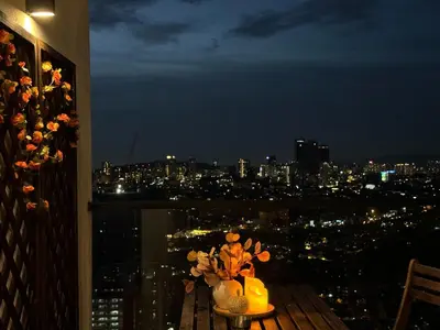 a room with a view of a city at night at The Establishment - Menara Teguh Bangsar in Kuala Lumpur