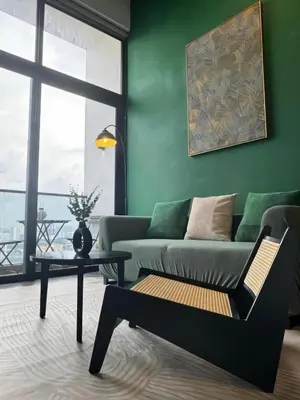 a living room with a couch and a table at The Establishment - Menara Teguh Bangsar in Kuala Lumpur