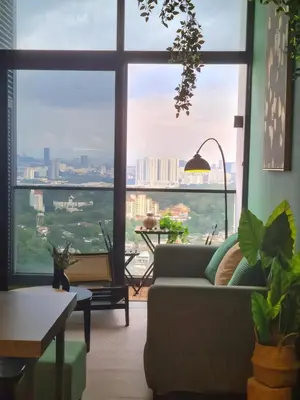 a living room with a couch and a large window at The Establishment - Menara Teguh Bangsar in Kuala Lumpur