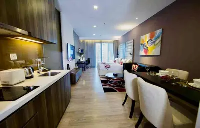 a kitchen and living room with a table and chairs at Exclusive Suites Bukit Bintang KL in Kuala Lumpur