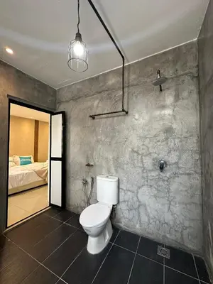 a bathroom with a toilet and a bedroom at Homigo - PWTC in Kuala Lumpur