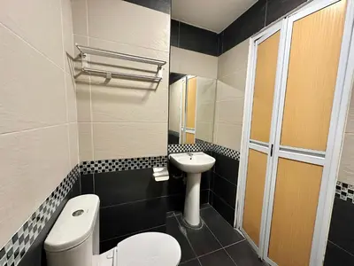 a small bathroom with a toilet and a sink at Homigo - PWTC in Kuala Lumpur
