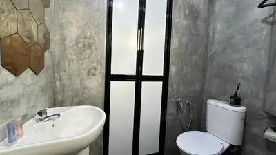 a bathroom with a white toilet and a sink at Homigo - PWTC in Kuala Lumpur