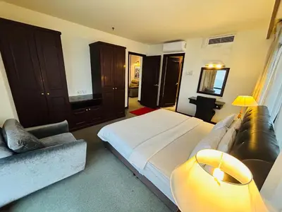 a bedroom with a large bed and a couch at EVERYDAY SERVICE SUITE at TIMES SQUARE in Kuala Lumpur
