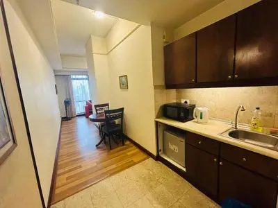 a small kitchen with a sink and a table at EVERYDAY SERVICE SUITE at TIMES SQUARE in Kuala Lumpur