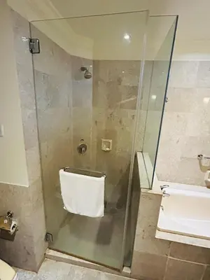 a shower in a bathroom with a glass door at EVERYDAY SERVICE SUITE at TIMES SQUARE in Kuala Lumpur
