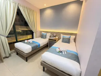 a hotel room with two beds and a window at AQ Hotel Bukit Bintang in Kuala Lumpur