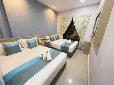 a hotel room with two beds and a window at AQ Hotel Bukit Bintang in Kuala Lumpur