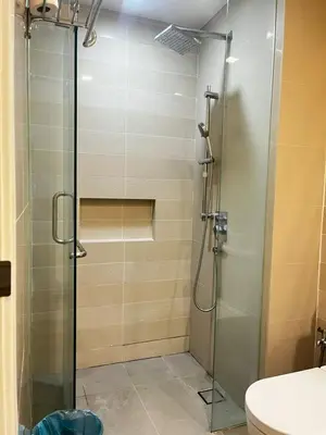 a shower with a glass door in a bathroom at One Bukit Ceylon AT Bukit Bintang Kuala Lumpur in Kuala Lumpur