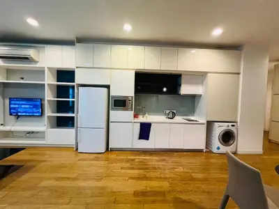 a kitchen with white cabinets and a refrigerator at The Platinum KLCC by Dream Suites in Kuala Lumpur
