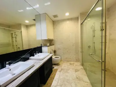 a bathroom with two sinks and a shower and a toilet at The Platinum KLCC by Dream Suites in Kuala Lumpur