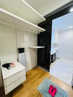 a room with a white kitchen with a pink flower on the floor at The Platinum KLCC by Dream Suites in Kuala Lumpur