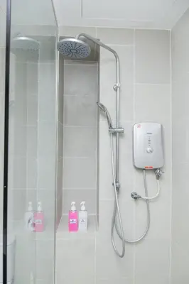 a bathroom with a shower with a glass door at KL Gateway Bangsar by Sleepy Bear in Kuala Lumpur