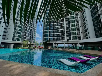 a swimming pool with lounge chairs and buildings at JMZ homestay in Kuala Lumpur