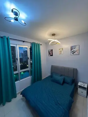 a bedroom with a blue bed and a window at JMZ homestay in Kuala Lumpur