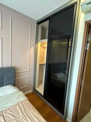 a bedroom with a large glass closet with a bed at Urban Sky Home with KLCC view at SKY SUITES Two Bed Rooms Apartment in Kuala Lumpur