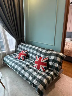 a couch in a living room with pillows on it at Urban Sky Home with KLCC view at SKY SUITES Two Bed Rooms Apartment in Kuala Lumpur