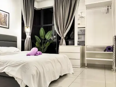 a bedroom with a white bed and a mirror at Scenic Living Homestay Studio in Kuala Lumpur