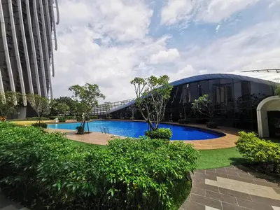 a large building with a large blue swimming pool at Scenic Living Homestay Studio in Kuala Lumpur