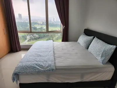 a bed in a room with a large window at 231tr facing golf view 3 rooms in Kuala Lumpur