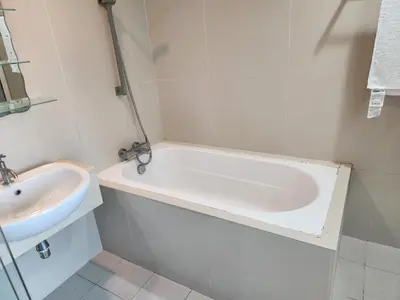a bathroom with a bath tub and a sink at 231tr facing golf view 3 rooms in Kuala Lumpur