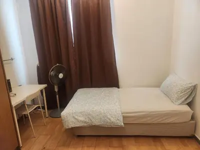 a small bedroom with a bed and a desk at 231tr facing golf view 3 rooms in Kuala Lumpur