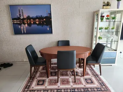 a dining room with a wooden table and chairs at 231tr facing golf view 3 rooms in Kuala Lumpur