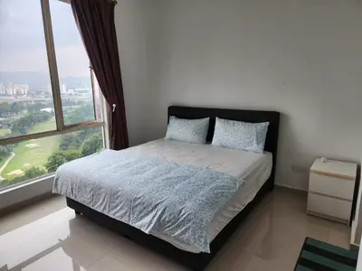 a bedroom with a bed and a large window at 231tr facing golf view 3 rooms in Kuala Lumpur