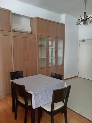 a kitchen with a table with chairs and cabinets at Park view klcc by Alan in Kuala Lumpur