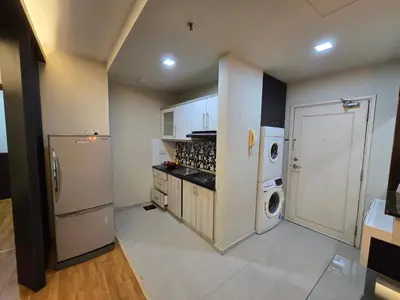 a kitchen with a refrigerator and a washer and dryer at Park view klcc by Alan in Kuala Lumpur