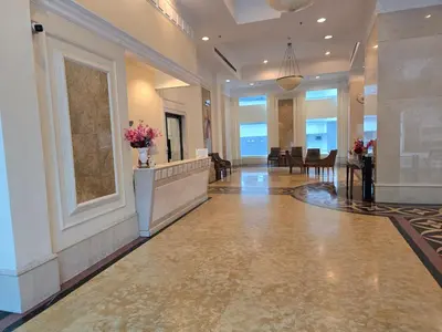 a lobby with a reception desk and flowers on the wall at Park view klcc by Alan in Kuala Lumpur