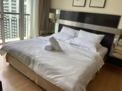 a white teddy bear sitting on top of a bed at City centre, Bukit Bintang in Kuala Lumpur