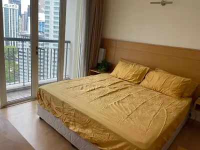 a bed in a bedroom with a large window at City centre, Bukit Bintang in Kuala Lumpur