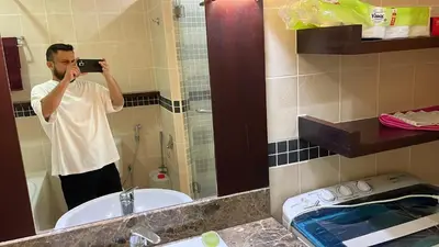 a man taking a picture of himself in a bathroom mirror at City centre, Bukit Bintang in Kuala Lumpur