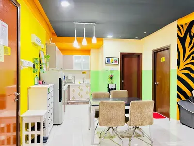 a kitchen and dining room with a table and chairs at Regalia Space Hostel in Kuala Lumpur