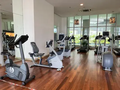 a gym with a bunch of exercise bikes in a room at Regalia Space Hostel in Kuala Lumpur