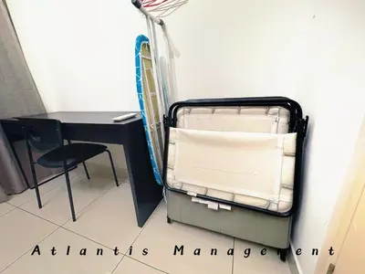 a bed in a room with a desk and a chair at Parc 3, Taman Pertama, Kuala Lumpur By Atlantis Management in Kuala Lumpur